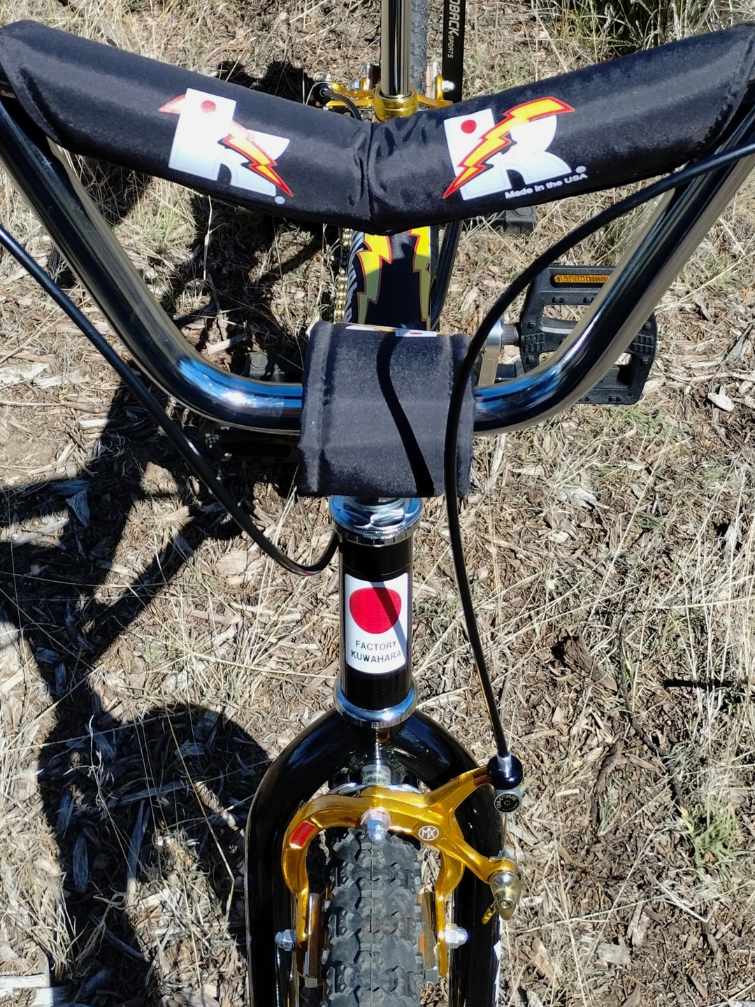 close up kuwahara black bmx bicycle with v-bar pads. 