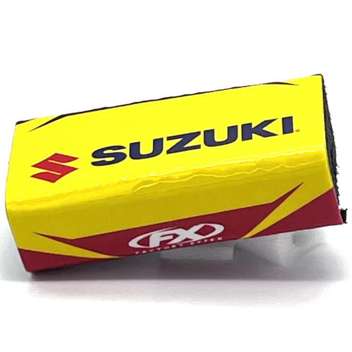 Yellow buldge pad with Suzuki symbol,